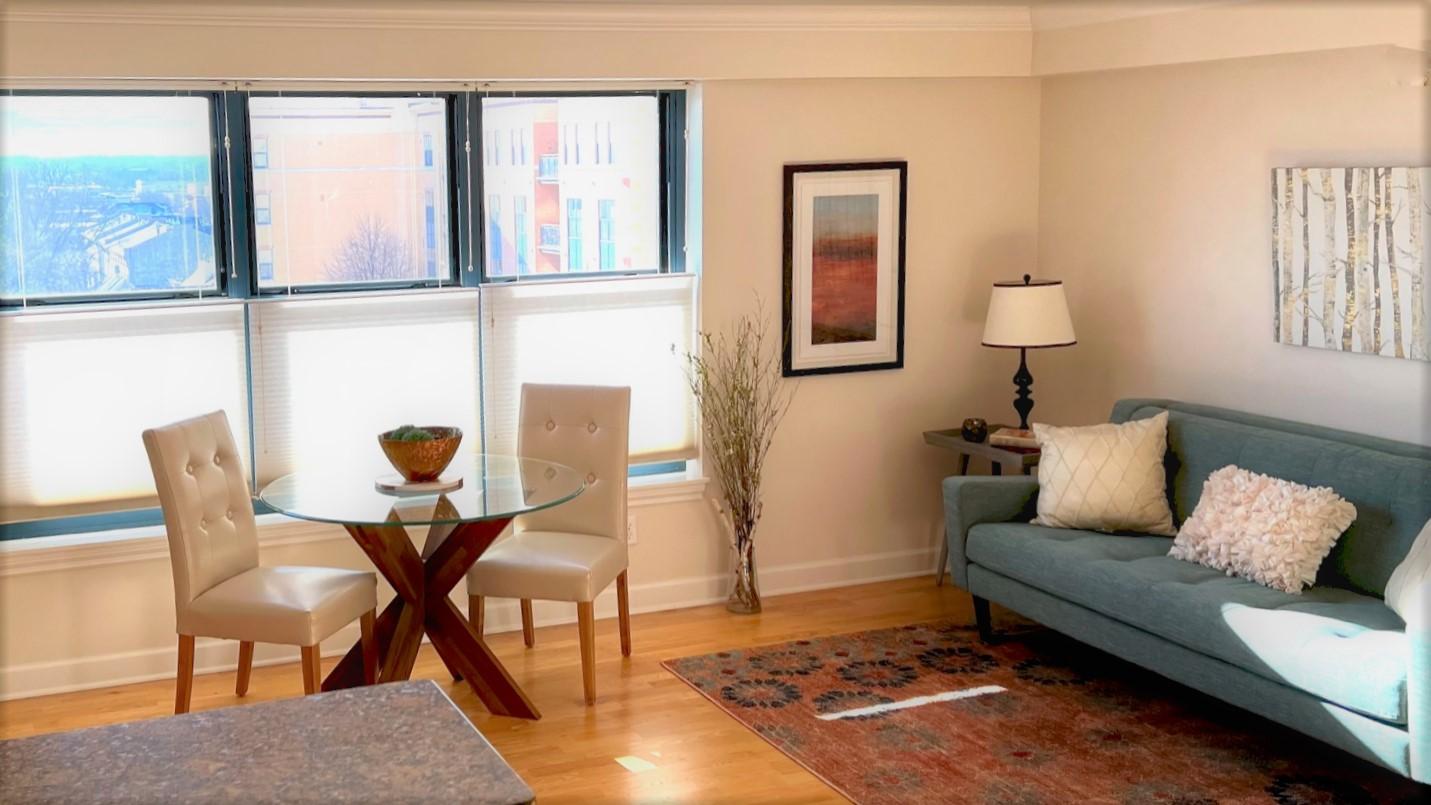 A dining room and living area in The Heights floor plan.