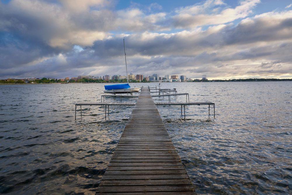 Photo of a dock with the Madison skyline in the background.