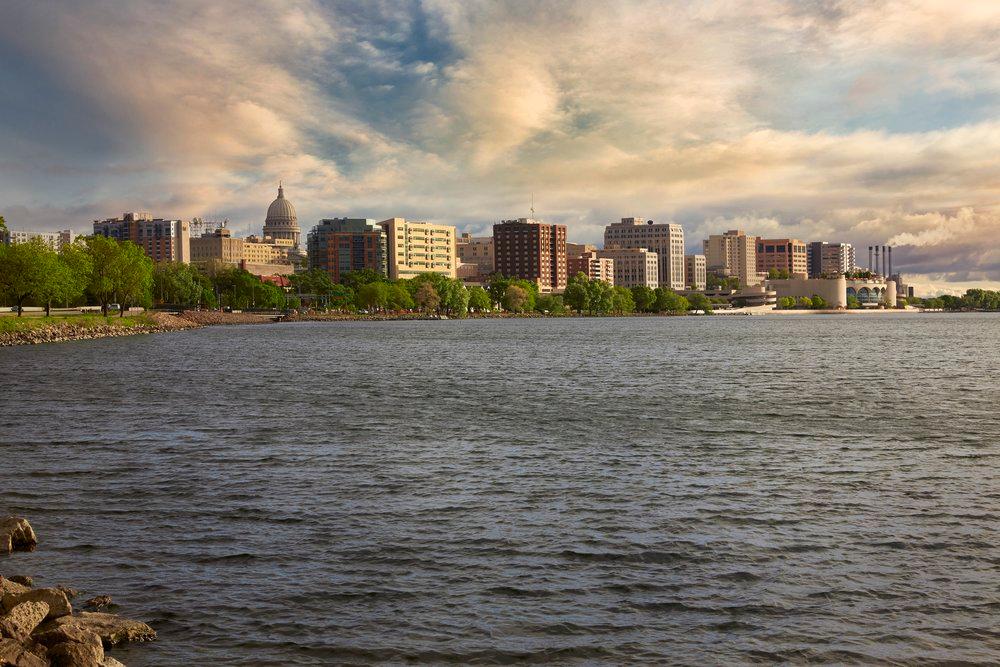 Photo of a lake with the Madison skyline in the background.