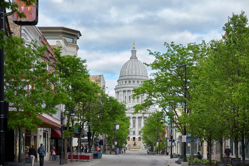 A street view a tree-lined street with the Capitol Lakes building in the background.