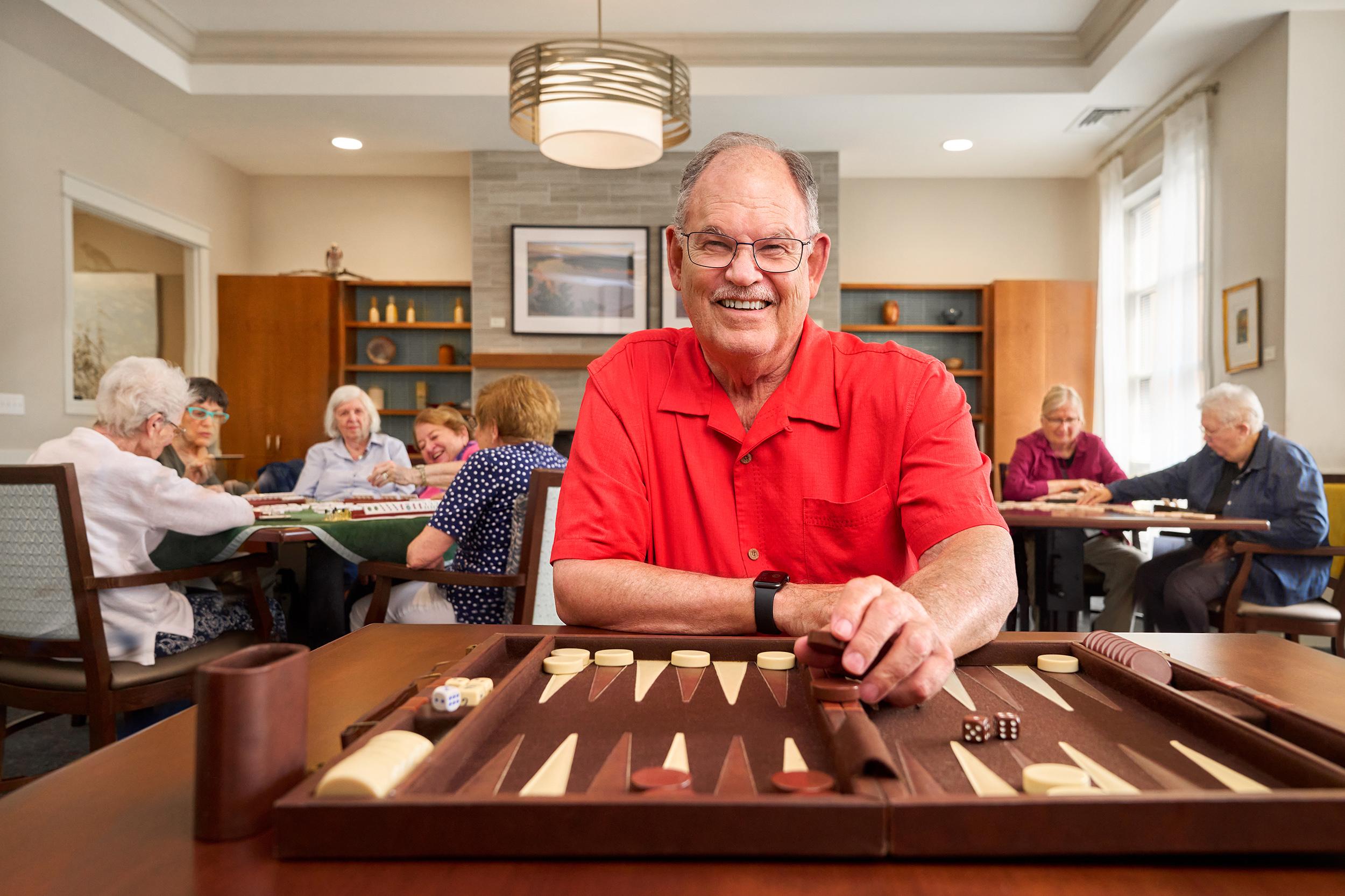 Pete, a Capitol Lakes resident, playing a board game.