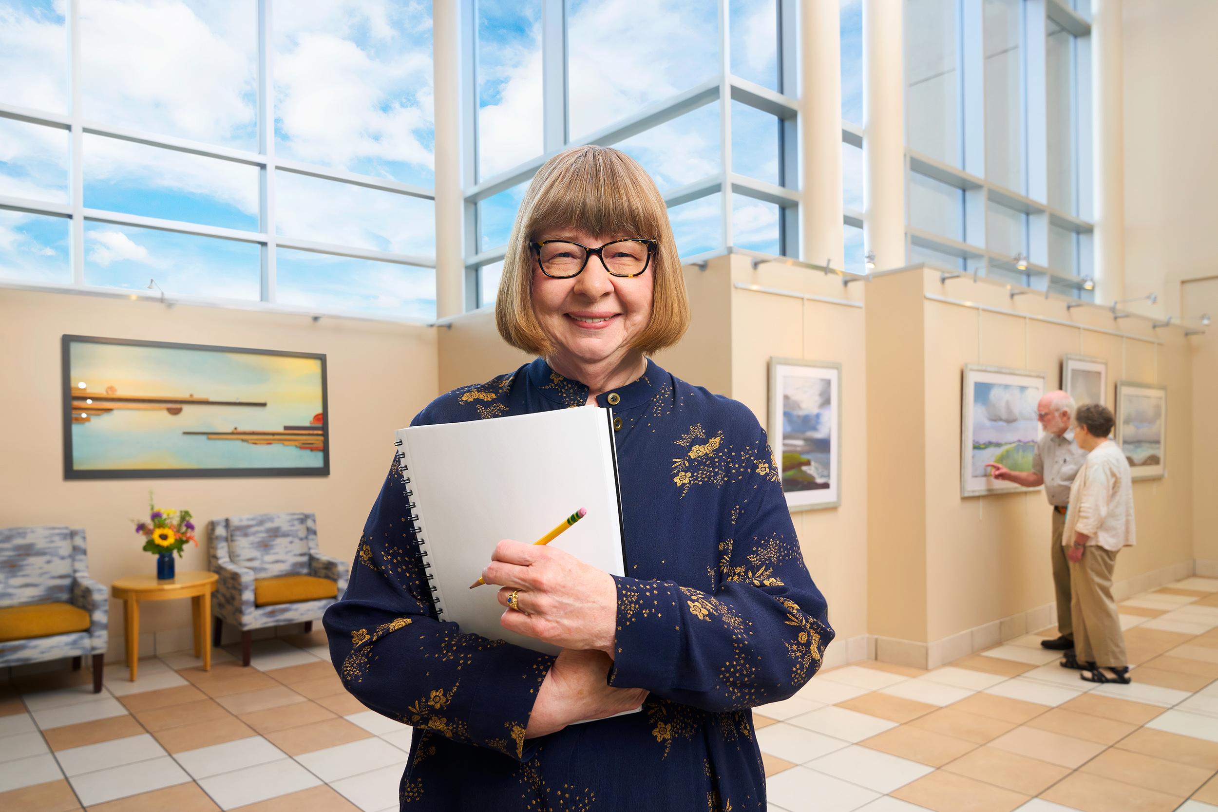 Janice, a Capitol Lakes resident, stands in front of an art gallery.