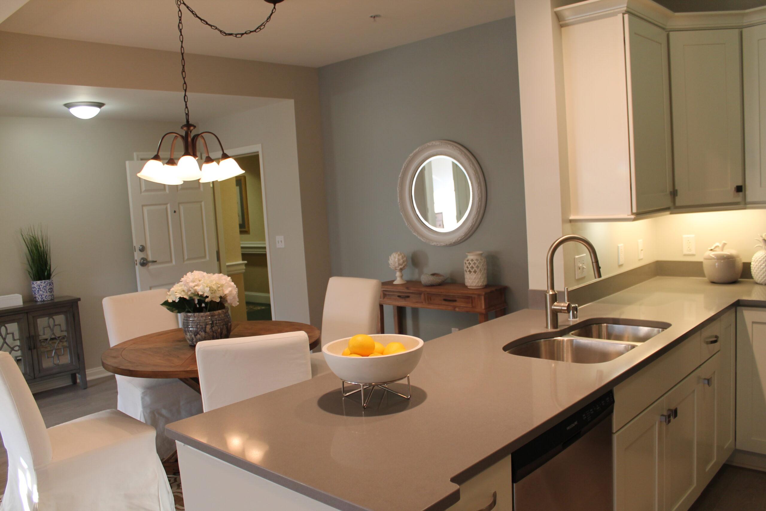 A kitchen and living space in the Reno floor plan.