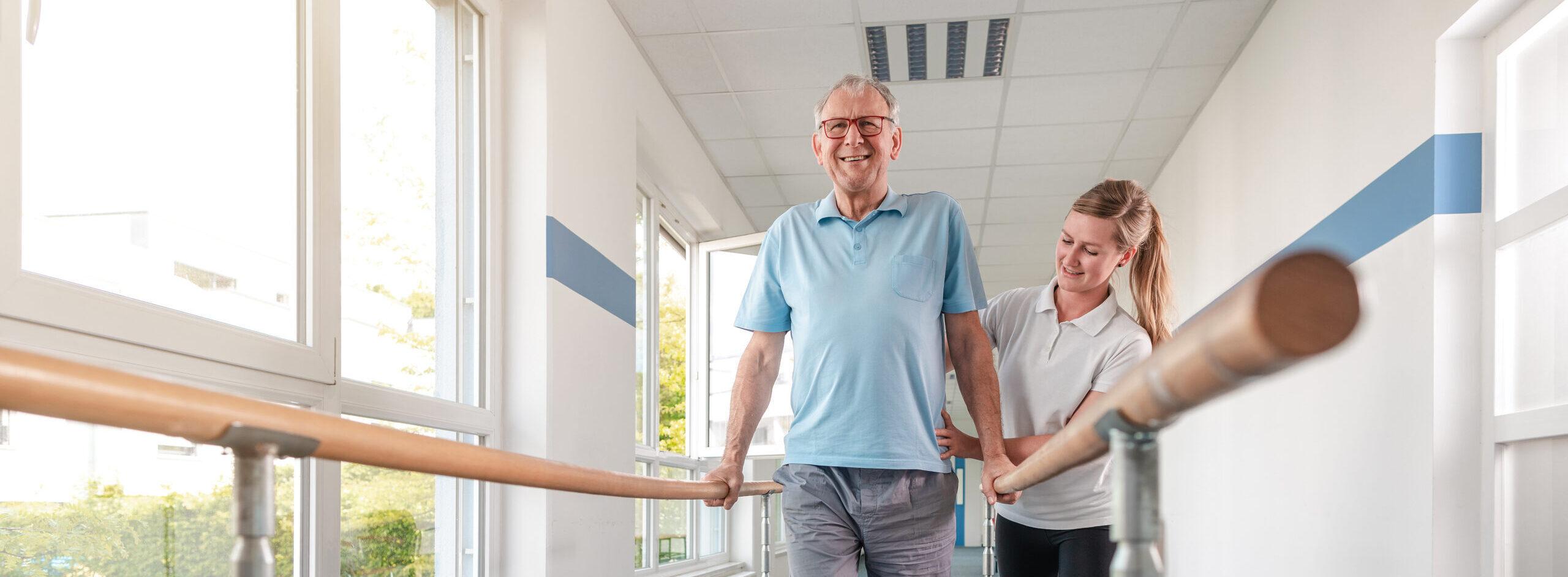 Senior Patient and physical therapist in rehabilitation walking exercises, she is helping him along the bars